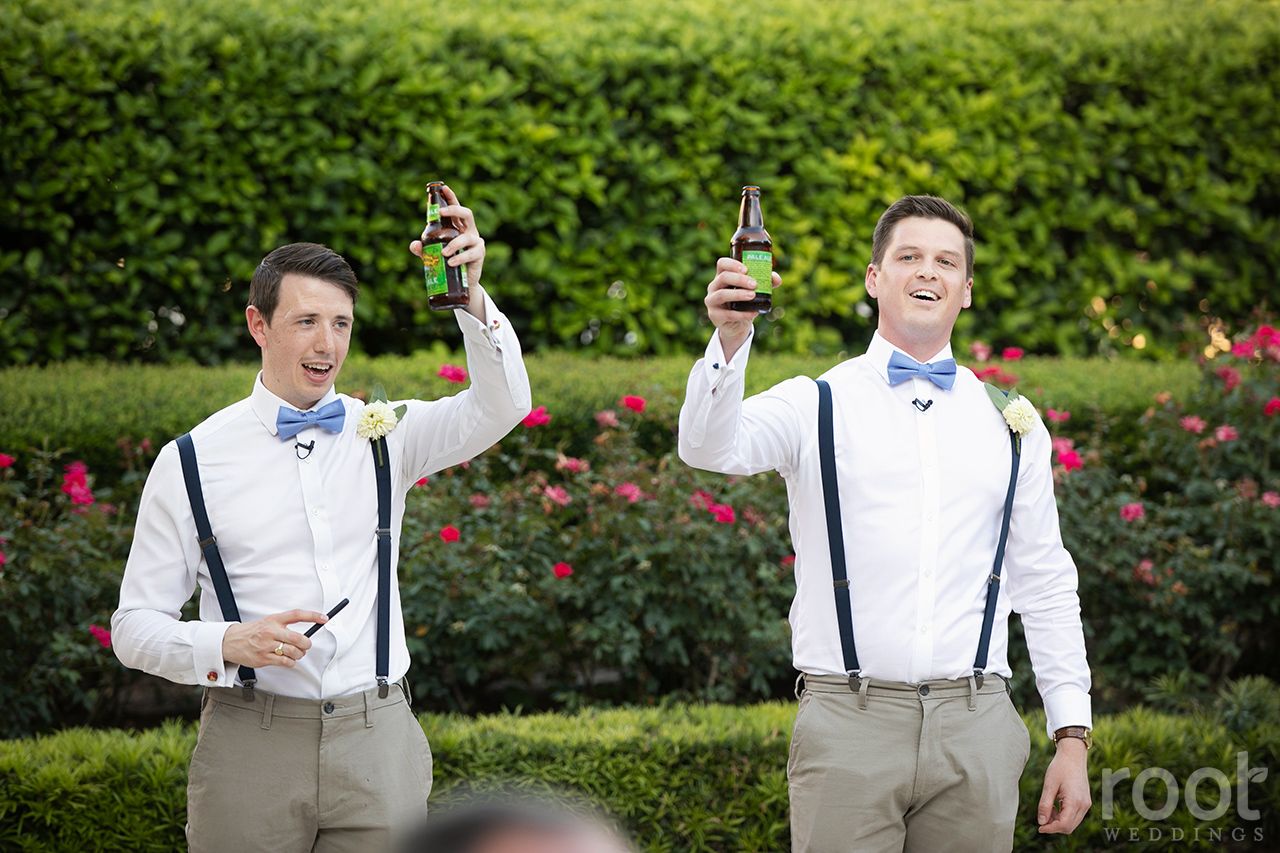 Groomsmen toast the groom at a wedding reception on the Whitehall Patio at Disney's Grand F