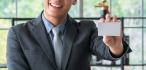 Young asian businessman wearing a suit hold and showing front side view